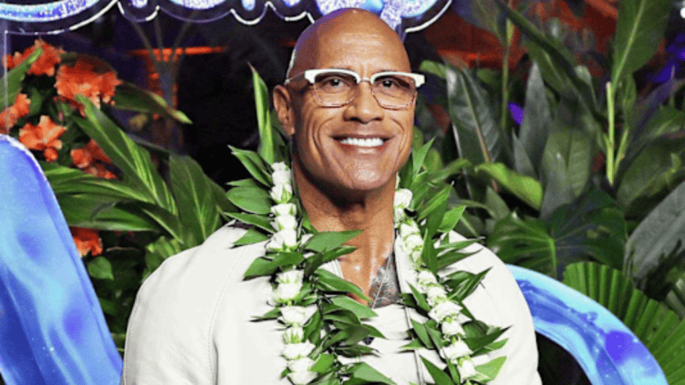 Sorry Internet, Maui Was Never Allowed To Be Bald Dwayne Johnson as Maui wearing his long curly wig in Disney's live-action Moana.